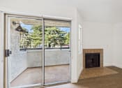 Thumbnail 40 of 60 - A room with a fireplace and sliding glass doors.