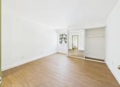 Thumbnail 43 of 60 - A room with a wooden floor and white walls.