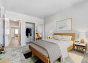 Thumbnail 6 of 18 - A bedroom with a large bed and a painting on the wall.