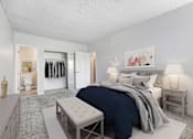 Thumbnail 5 of 18 - A bedroom with a bed, nightstand, and a bench.