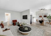 Thumbnail 10 of 18 - A modern living room with a black coffee table in the center.