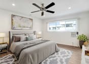 Thumbnail 7 of 67 - A bedroom with a large bed and a ceiling fan.