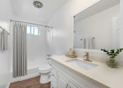 Thumbnail 10 of 67 - A white bathroom with a toilet, sink, and shower.