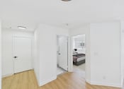 Thumbnail 8 of 38 - A white bedroom with a round light fixture on the ceiling.