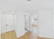 Thumbnail 42 of 46 - A white room with a door and a window.
