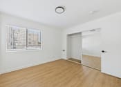 Thumbnail 44 of 46 - A room with a white wall and a window with blinds.