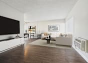 Thumbnail 19 of 36 - A living room with a white couch and a wooden floor.