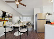 Thumbnail 16 of 36 - A modern kitchen with a dining table set for two.