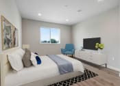 Thumbnail 7 of 12 - a bedroom with a bed and a tv in a room