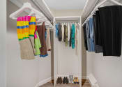 Thumbnail 9 of 12 - a walk in closet with a white closet organizer