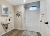 Thumbnail 11 of 12 - a bathroom with a sink and a bathtub