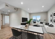 Thumbnail 3 of 12 - a living room with white walls and hardwood floors