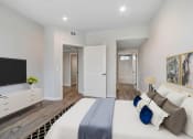 Thumbnail 6 of 12 - a bedroom with a large bed and a tv
