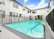 Thumbnail 16 of 17 - a swimming pool in front of a white building