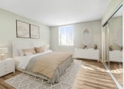 Thumbnail 5 of 39 - a bedroom with a bed and a mirrored closet