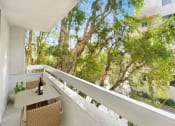 Thumbnail 4 of 39 - a balcony with a table and a bottle of wine on it