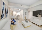 Thumbnail 5 of 39 - a living room with a white couch and a television