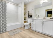 Thumbnail 11 of 39 - a bathroom with white cabinets and a shower and a toilet