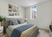Thumbnail 9 of 39 - a bedroom with a bed and pictures on the wall