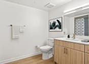 Thumbnail 15 of 45 - an empty bathroom with a toilet and a sink