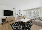 Thumbnail 17 of 50 - A living room with a black and white rug, a white coffee table, a grey couch, a wooden cabinet, a flat screen TV, and a ceiling fan.