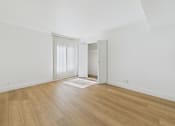 Thumbnail 38 of 50 - A room with wooden flooring and a sliding door.