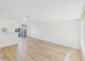 Thumbnail 46 of 50 - A room with wooden flooring and white walls.