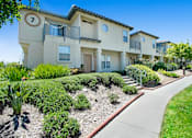 Thumbnail 6 of 11 - a walkway in front of an apartment building with a sidewalk