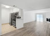 Thumbnail 14 of 85 - an empty room with a kitchen and a living room