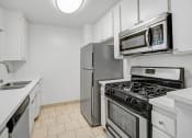 Thumbnail 12 of 85 - a kitchen with stainless steel appliances and white cabinets