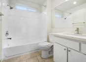 Thumbnail 21 of 85 - a bathroom with a toilet and a sink and a shower