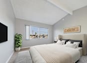 Thumbnail 8 of 23 - A bedroom with a large bed and a flat screen TV mounted on the wall.