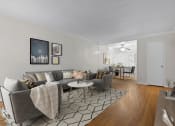 Thumbnail 8 of 35 - a living room with a couch and a chair and a dining room table