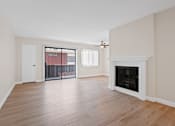 Thumbnail 12 of 18 - a living room with hardwood floors and a fireplace