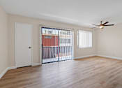 Thumbnail 13 of 18 - a bedroom with hardwood floors and a ceiling fan