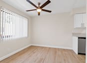 Thumbnail 14 of 18 - a bedroom with hardwood floors and a ceiling fan
