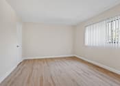 Thumbnail 15 of 18 - a bedroom with hardwood floors and a large window