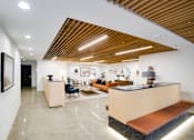 Thumbnail 3 of 119 - A reception area with a wooden ceiling and a white wall.