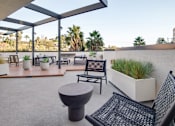Thumbnail 6 of 119 - A patio with a black chair and table.