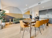 Thumbnail 2 of 119 - A modern dining room with a wooden table and yellow chairs.