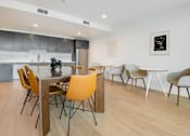 Thumbnail 15 of 119 - A modern dining room with a table and chairs.