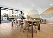 Thumbnail 8 of 119 - A dining room with a table and chairs.