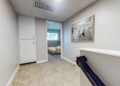 Thumbnail 16 of 34 - A room with a white door, a window, and a painting on the wall.