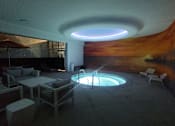 Thumbnail 95 of 95 - A modern outdoor seating area with a hot tub and a large mural on the wall.