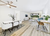 Thumbnail 62 of 127 - A dining room with a white table and chairs.