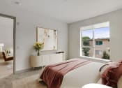 Thumbnail 5 of 45 - a bedroom with a bed and a large window