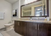 Thumbnail 7 of 45 - a bathroom with a toilet and a sink and a mirror