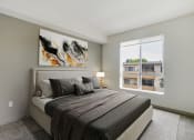Thumbnail 4 of 45 - a bedroom with a bed and a large window