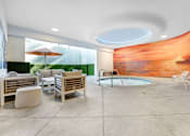 Thumbnail 87 of 95 - A modern outdoor seating area with a pool and a mural on the wall.