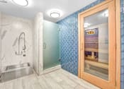 Thumbnail 91 of 95 - A bathroom with a marble wall and a glass shower door.